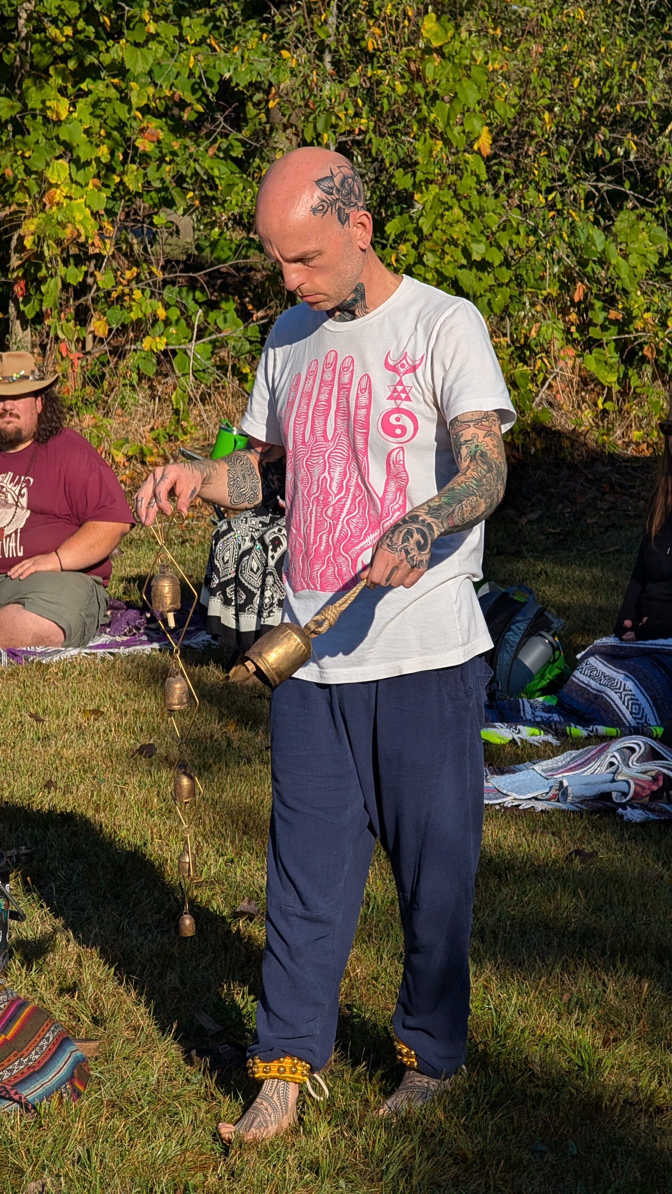 A musician making a sound offering outdoors